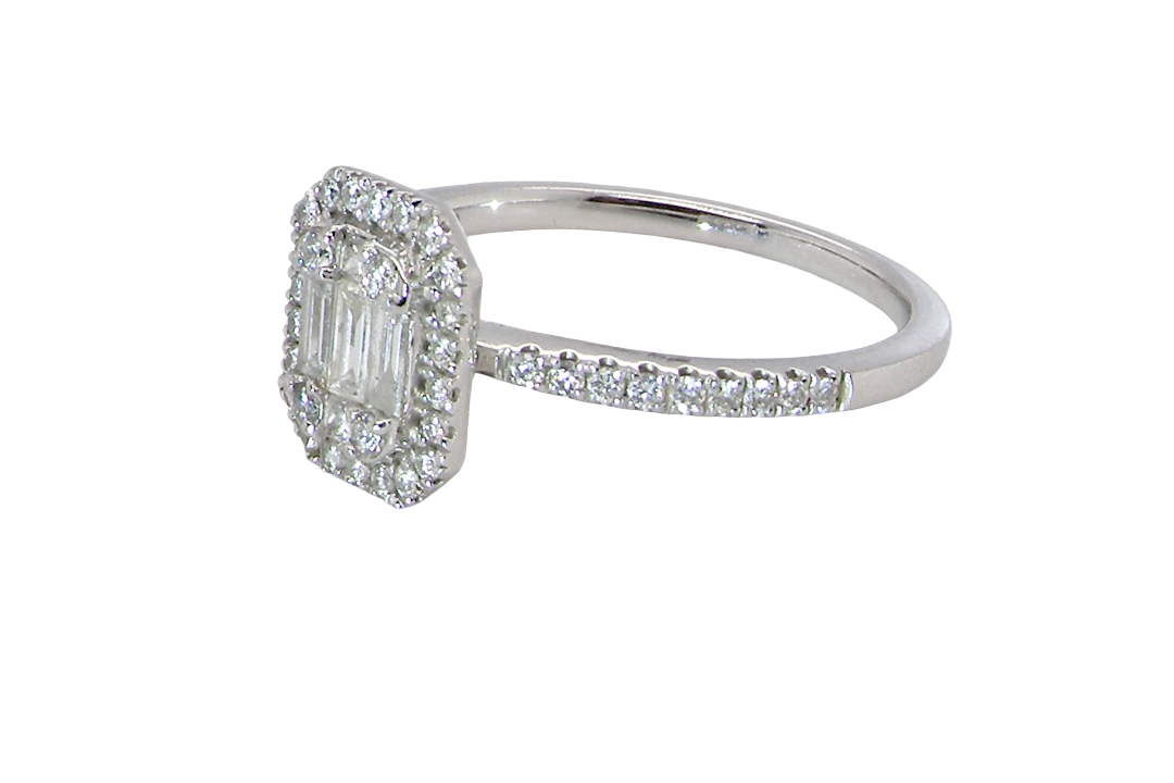 A rectangular diamond cluster ring. Centre portion is set with three baguette cut white diamonds 3x1.6mm and six mixed cut diamonds 2mm each. 