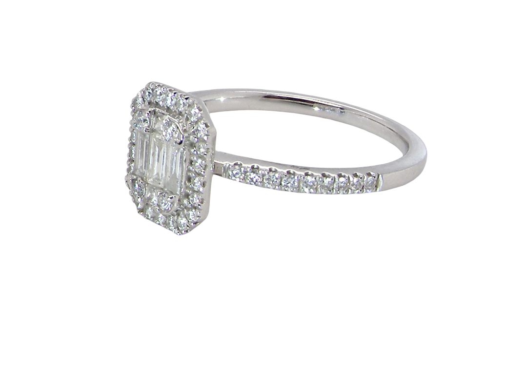 A rectangular diamond cluster ring. Centre portion is set with three baguette cut white diamonds 3x1.6mm and six mixed cut diamonds 2mm each. 