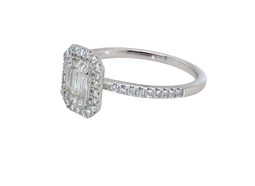 A rectangular diamond cluster ring. Centre portion is set with three baguette cut white diamonds 3x1.6mm and six mixed cut diamonds 2mm each. 