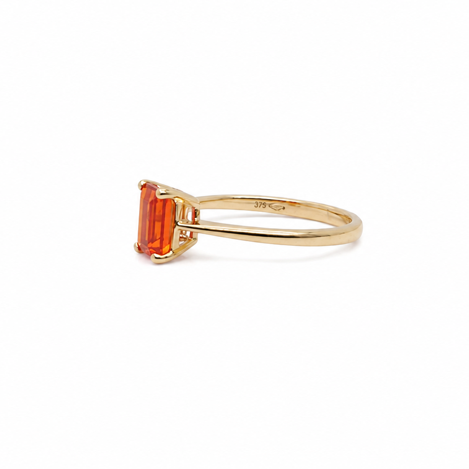 A rectangular fire opal solitaire ring side view