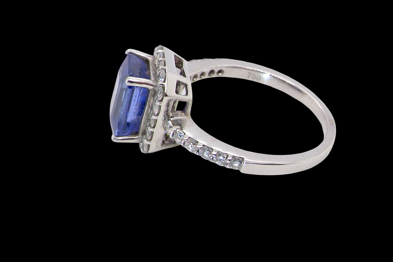 side cluster ring featuring a 4A quality Tanzanite as its centre stone. A