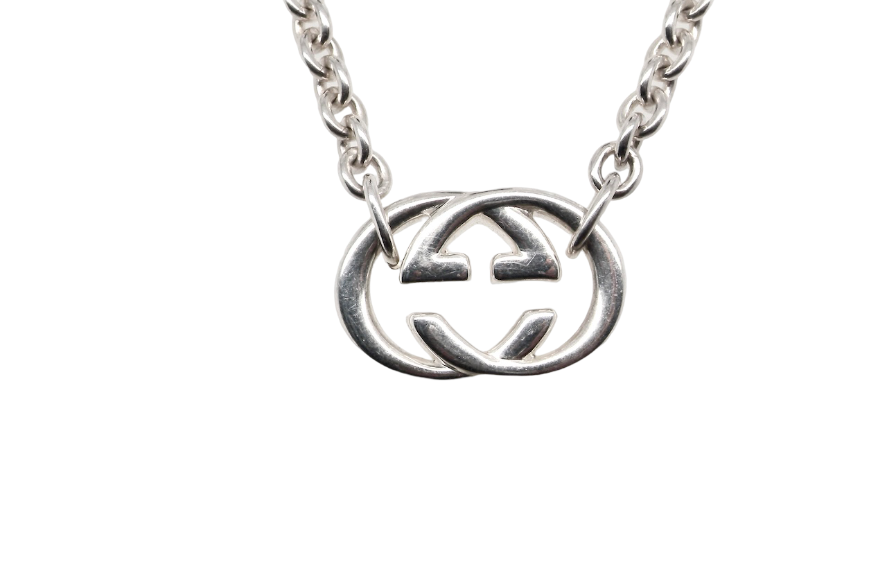 A silver Gucci GG pendant