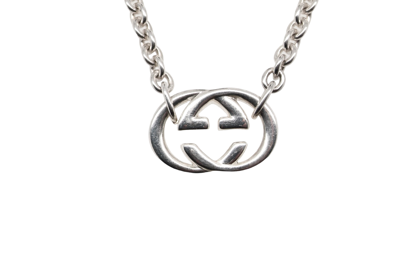 A silver Gucci GG pendant