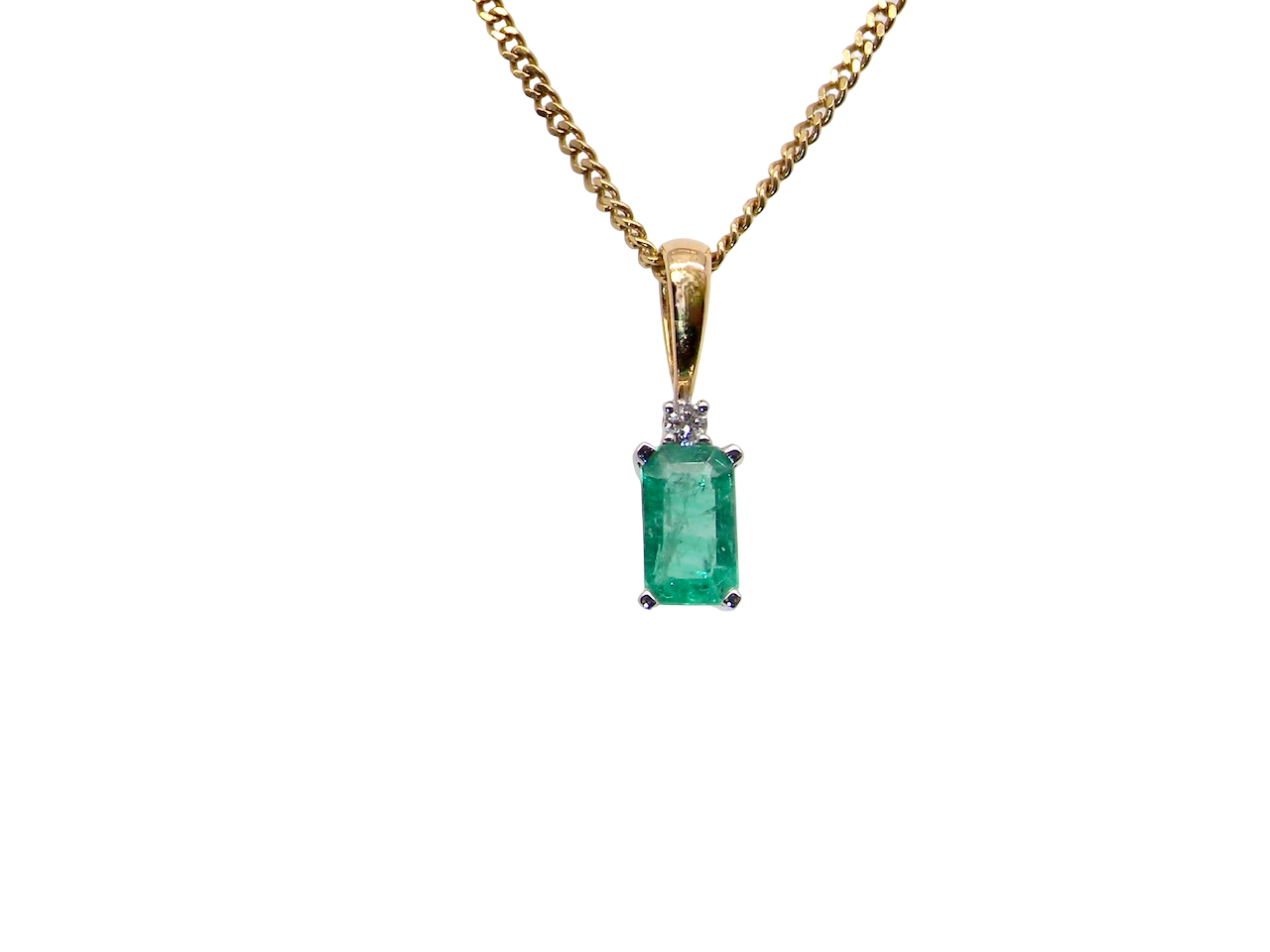 A simple and elegant pendant set with a rectangular emerald