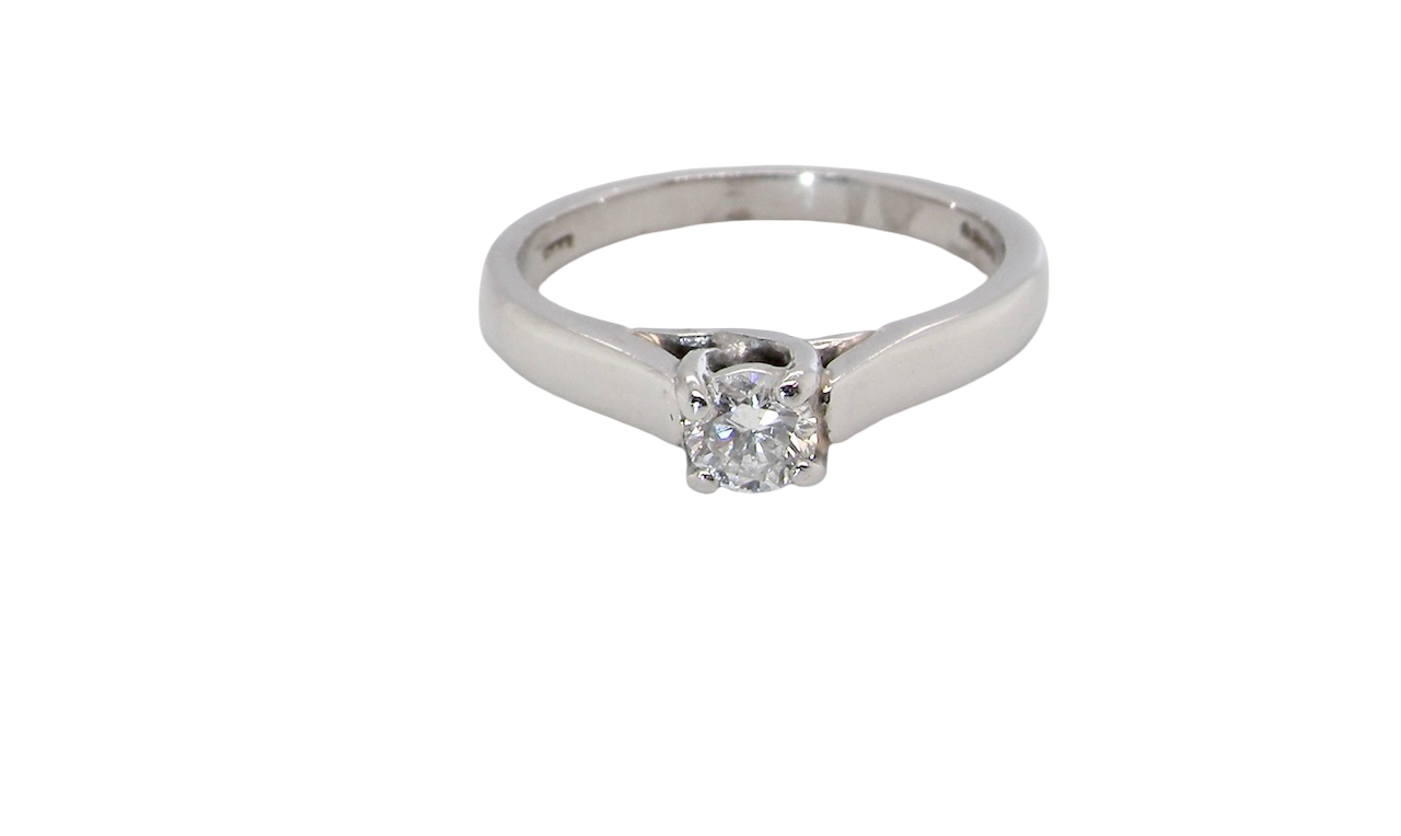 A single stone solitaire diamond ring. The modern brilliant cut white diamond measures 3.9mm (0.22 carats est) Colour G-h, clarity VS.
