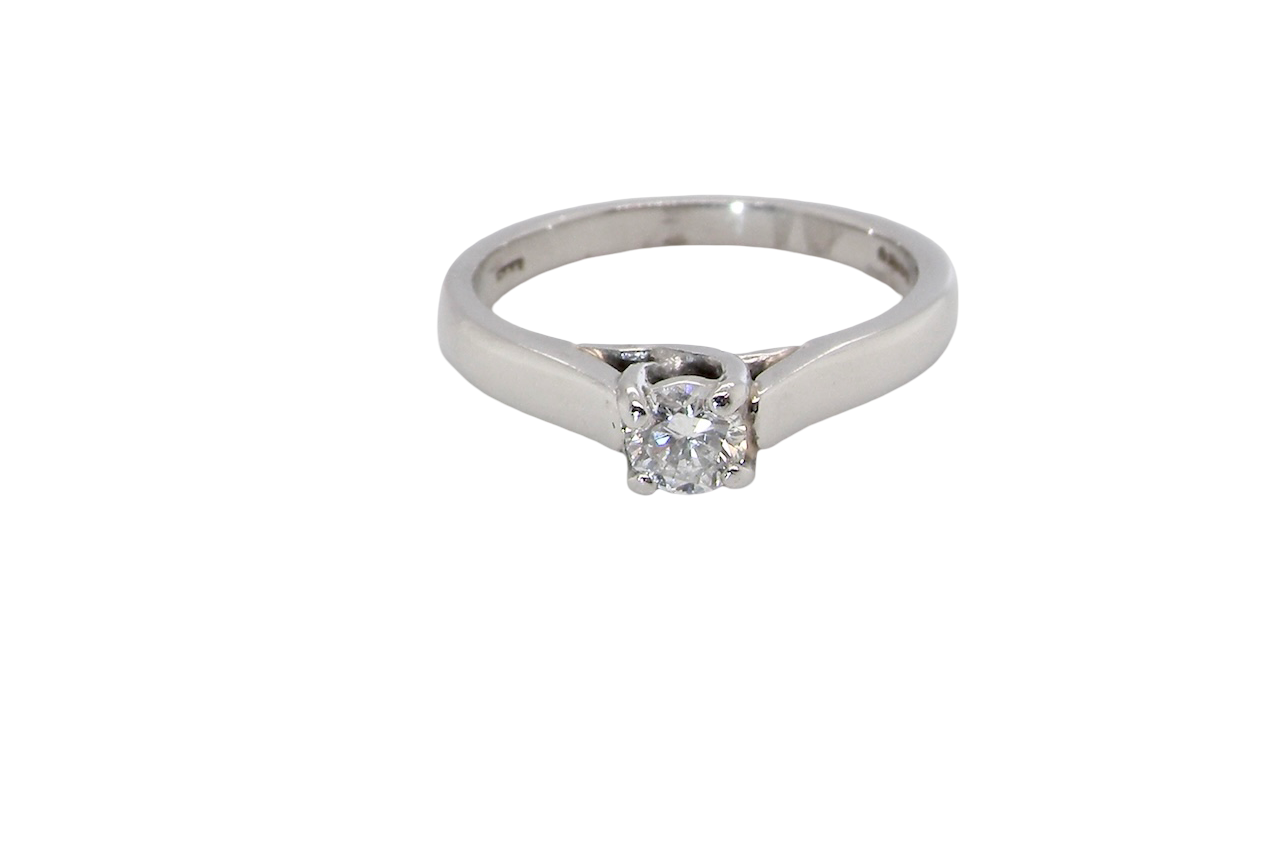 A single stone solitaire diamond ring. The modern brilliant cut white diamond measures 3.9mm (0.22 carats est) Colour G-h, clarity VS.