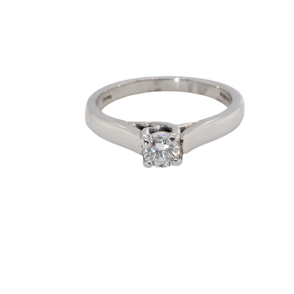 A single stone solitaire diamond ring. The modern brilliant cut white diamond measures 3.9mm (0.22 carats est) Colour G-h, clarity VS.
