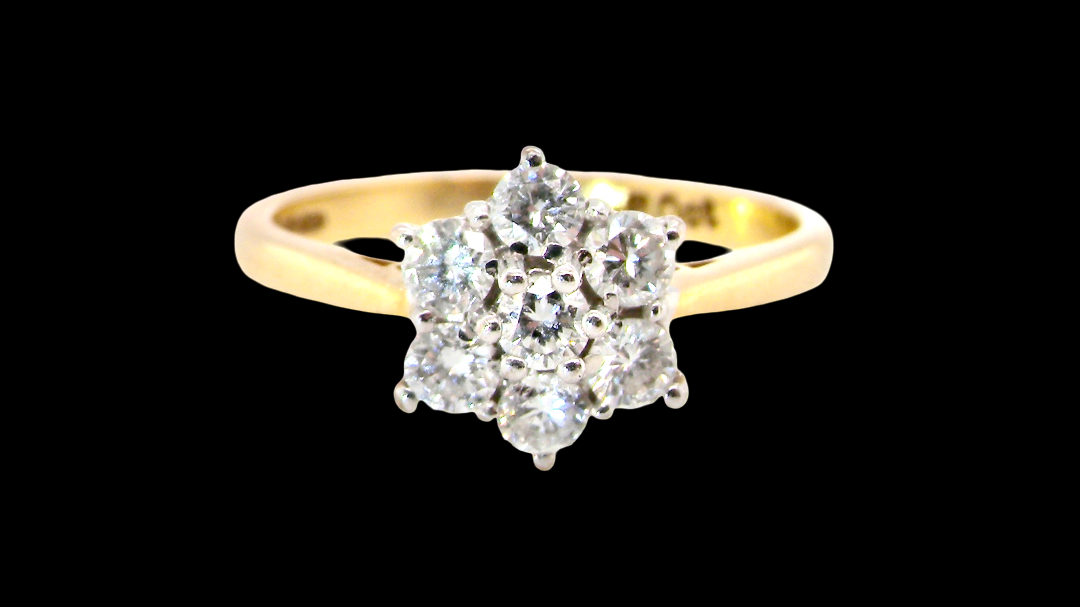 A small cluster ring set with seven bright white brilliant cut white diamonds.
Head measures 8.5mm, each diamond measures 2.8mm