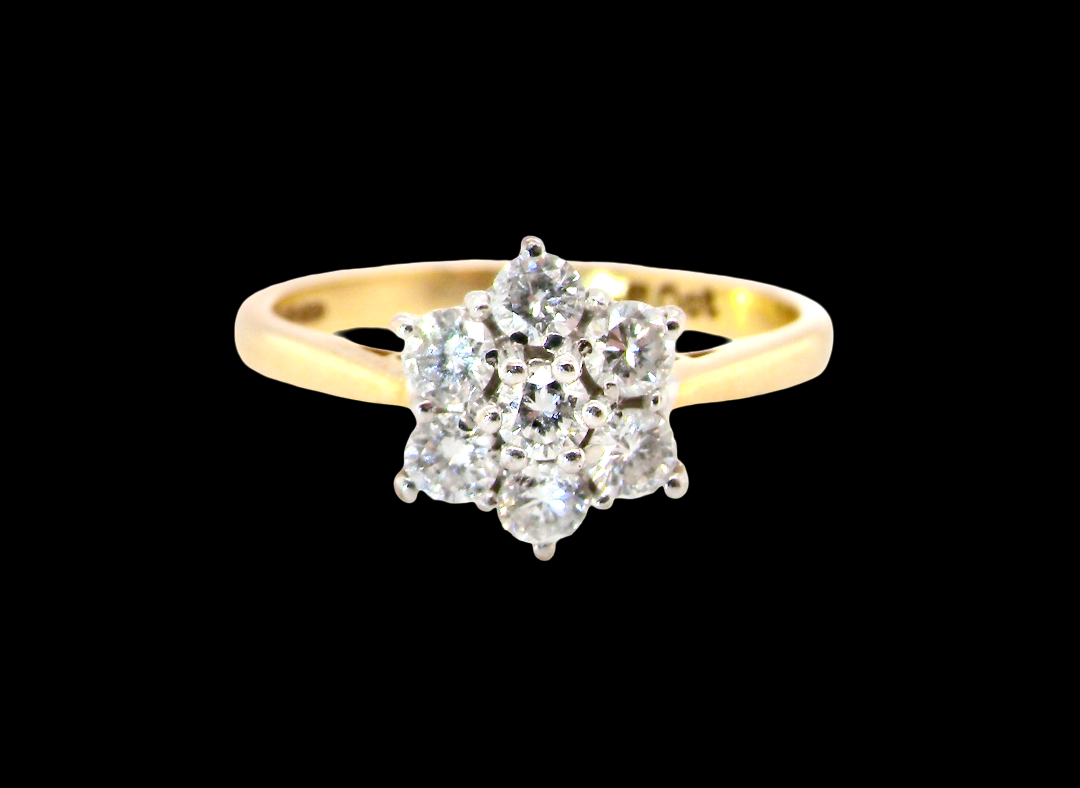 A small cluster ring set with seven bright white brilliant cut white diamonds.
Head measures 8.5mm, each diamond measures 2.8mm