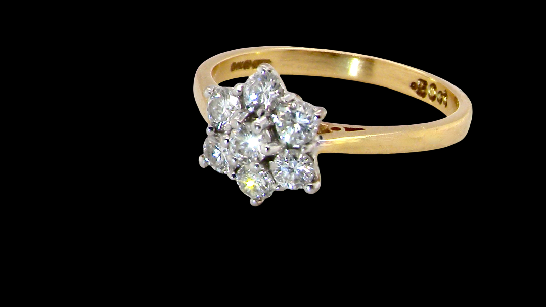 A small cluster ring set with seven bright white brilliant cut white diamonds.
Head measures 8.5mm, each diamond (total 0.50 carats