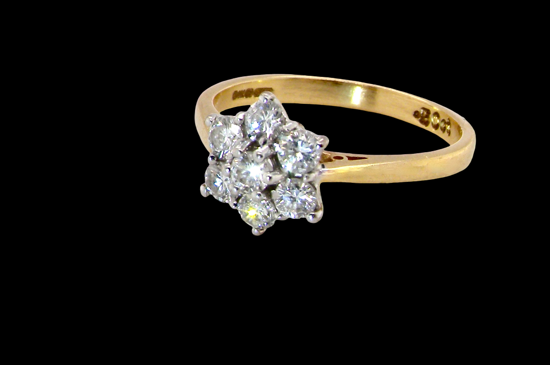 A small cluster ring set with seven bright white brilliant cut white diamonds.
Head measures 8.5mm, each diamond (total 0.50 carats