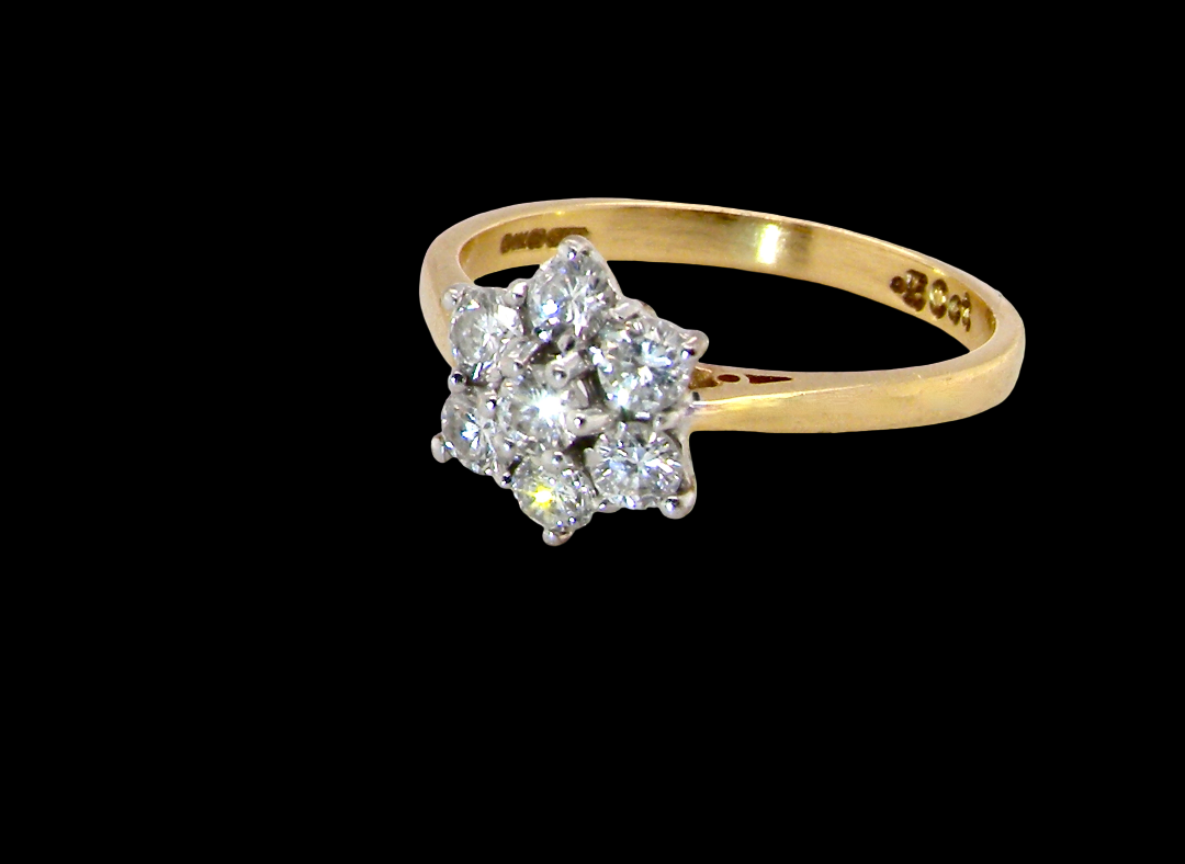 A small cluster ring set with seven bright white brilliant cut white diamonds.
Head measures 8.5mm, each diamond (total 0.50 carats