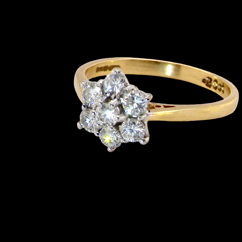 A small cluster ring set with seven bright white brilliant cut white diamonds.
Head measures 8.5mm, each diamond (total 0.50 carats