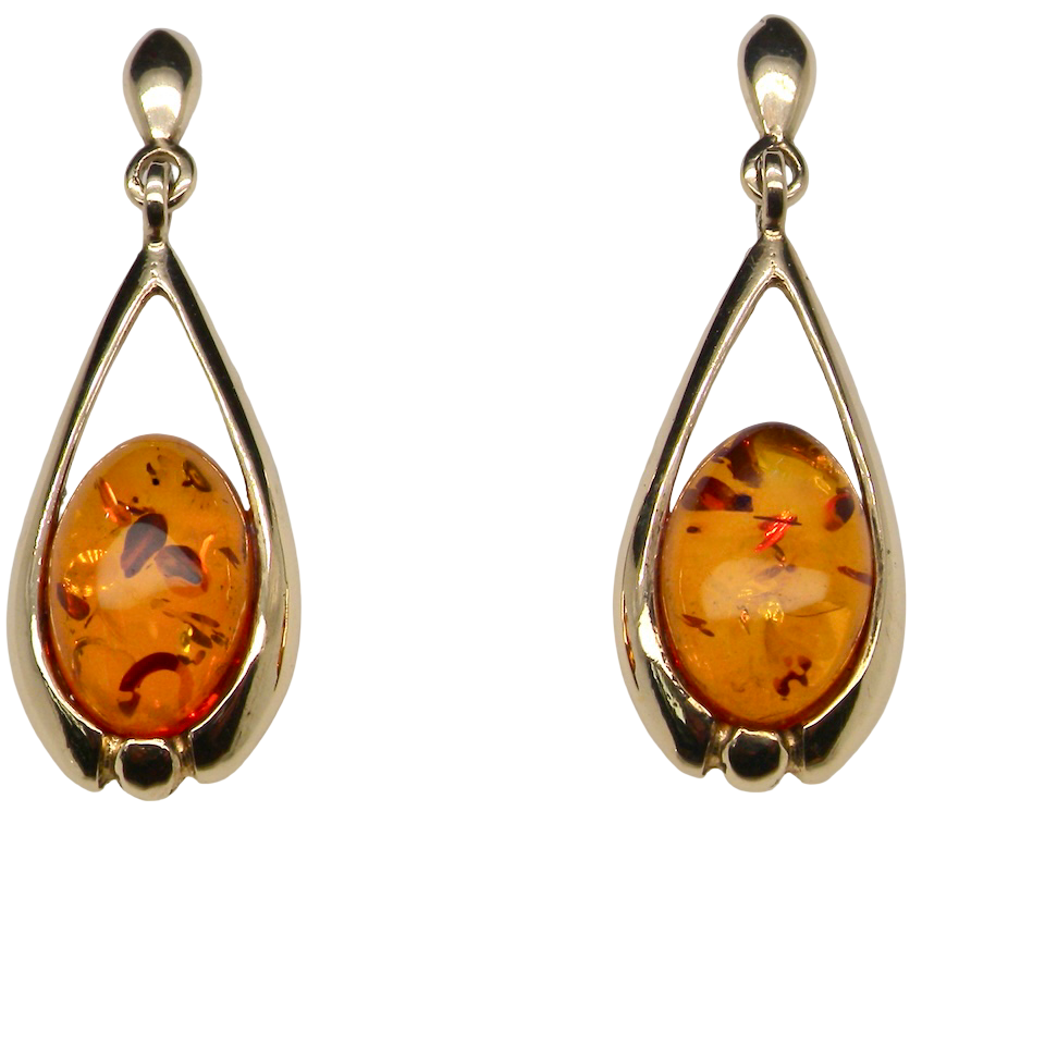 A smart pair of drop earrings, each containing an oval amber stone,