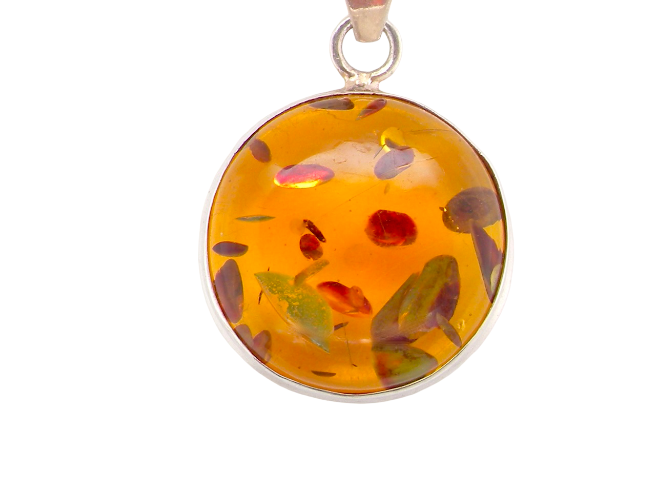 A sterling silver pendant. Features a large circular amber stone,