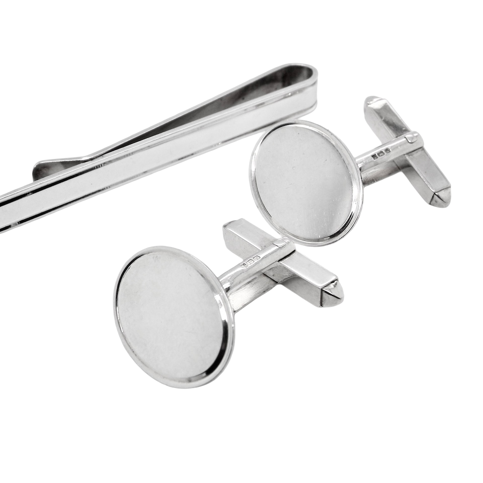 A sterling silver set. Consisting of a pair of plain oval shaped cufflinks. Head 17x13mm, torpedo fittings. Hallmarks for Birmingham 1994.