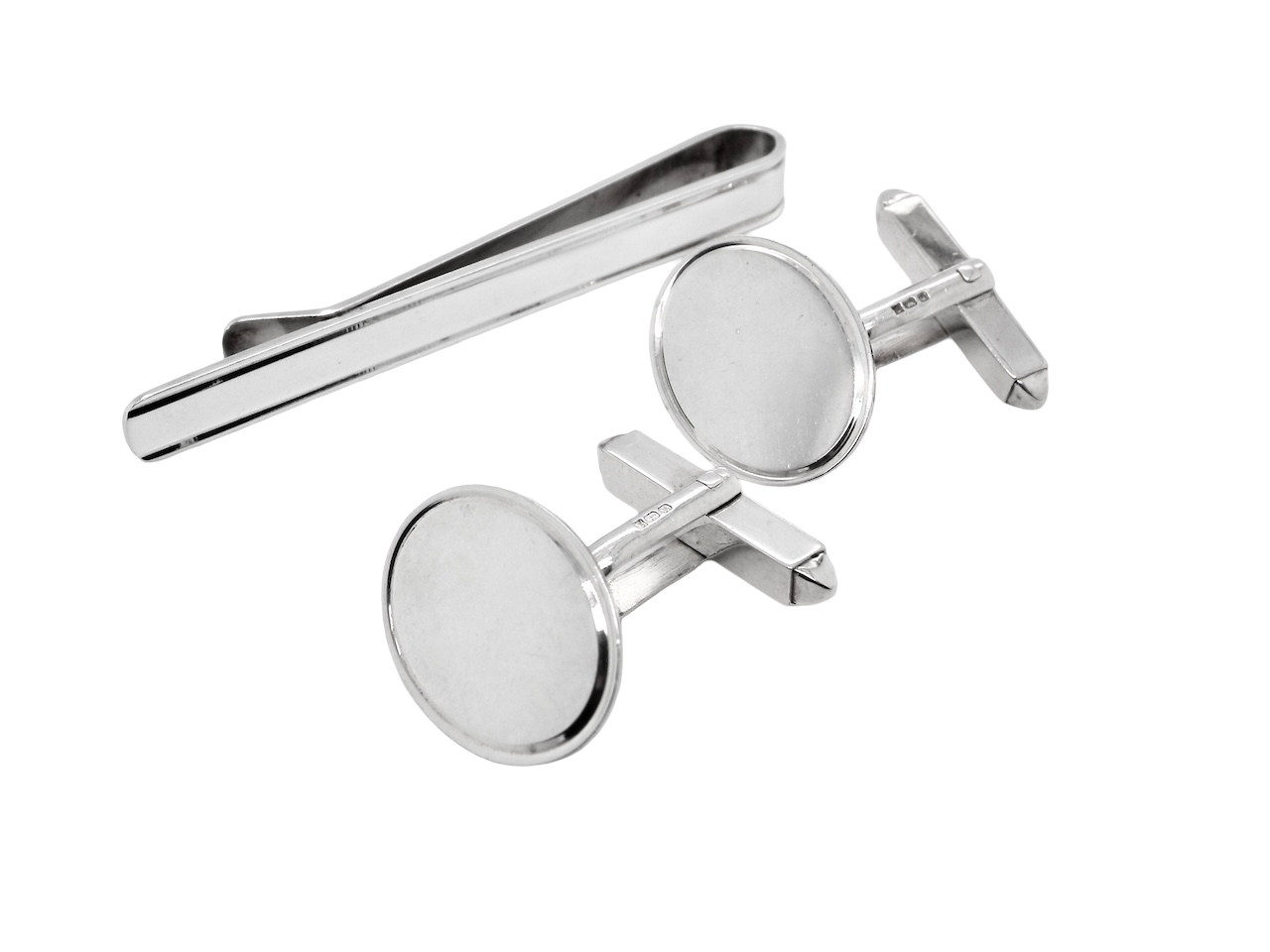 A sterling silver set. Consisting of a pair of plain oval shaped cufflinks. Head 17x13mm, torpedo fittings. Hallmarks for Birmingham 1994.