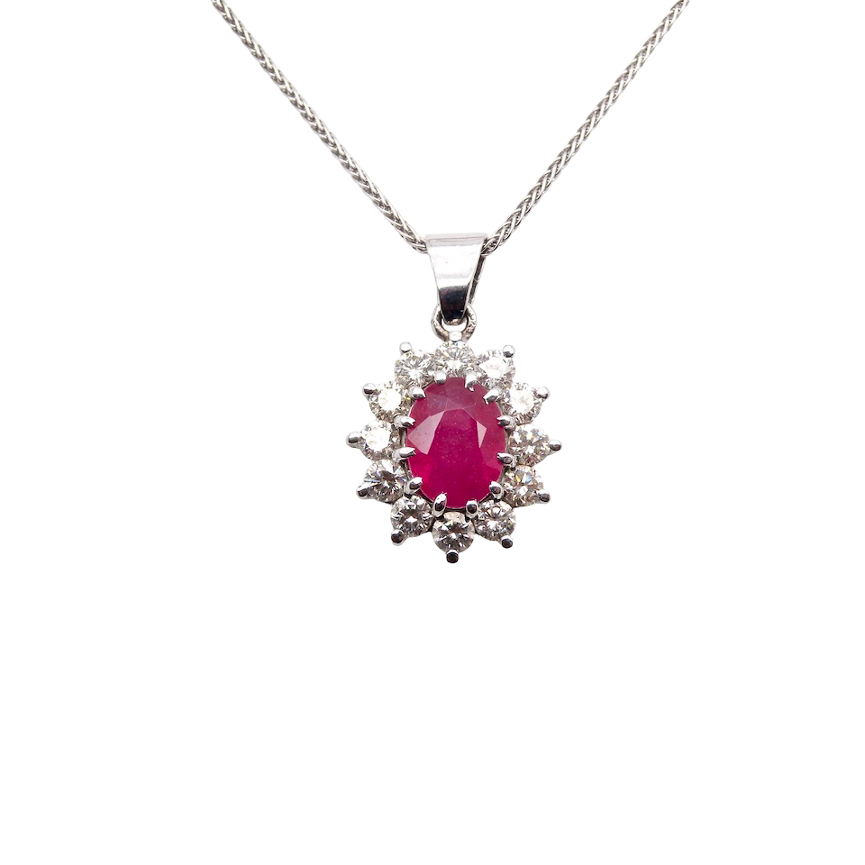A striking and elegant pendant crafted in 18-carat white gold, showcasing a vibrant oval-cut ruby of approximately 2.00 carats