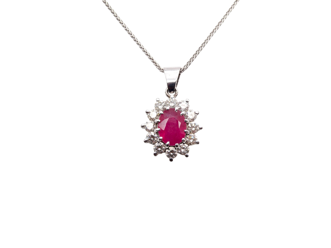 A striking and elegant pendant crafted in 18-carat white gold, showcasing a vibrant oval-cut ruby of approximately 2.00 carats