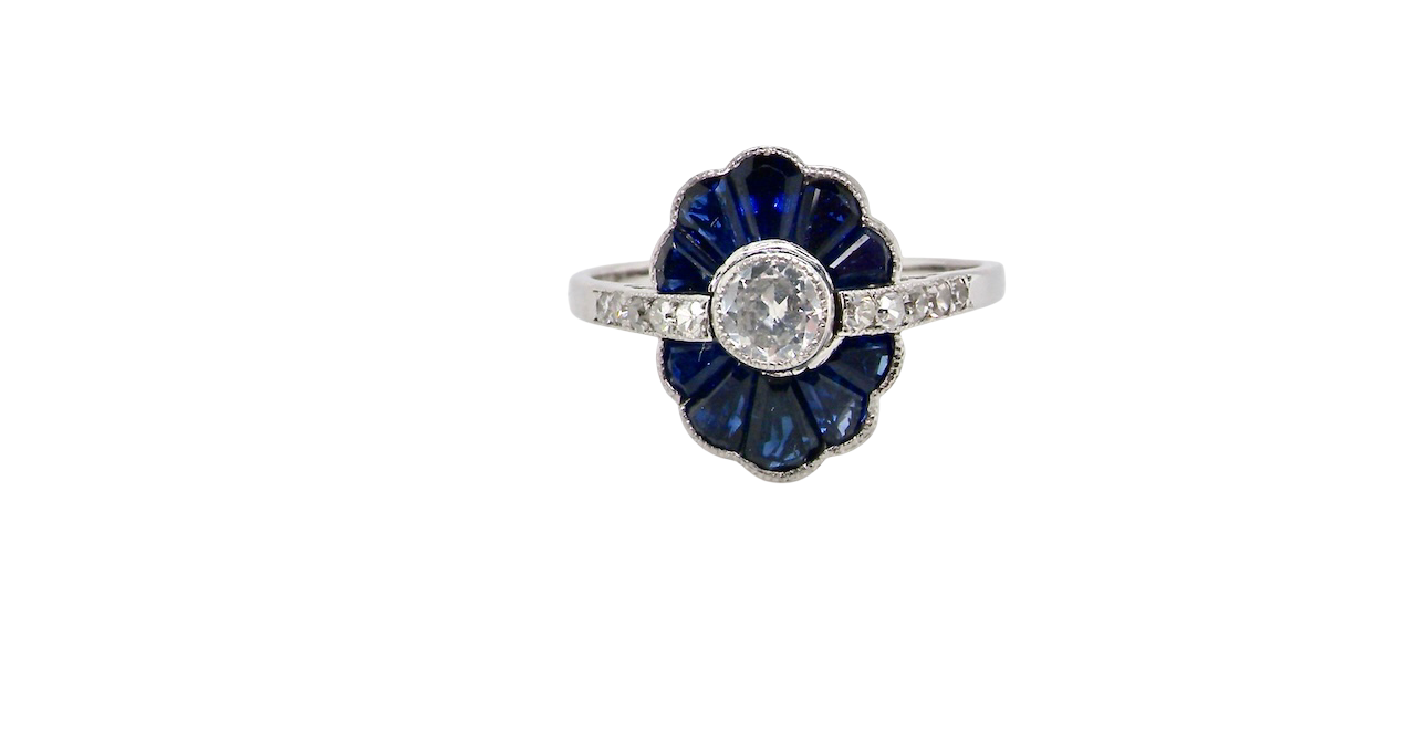 A striking and highly unusual Art Deco cluster ring featuring a distinctive fan-shaped design.
