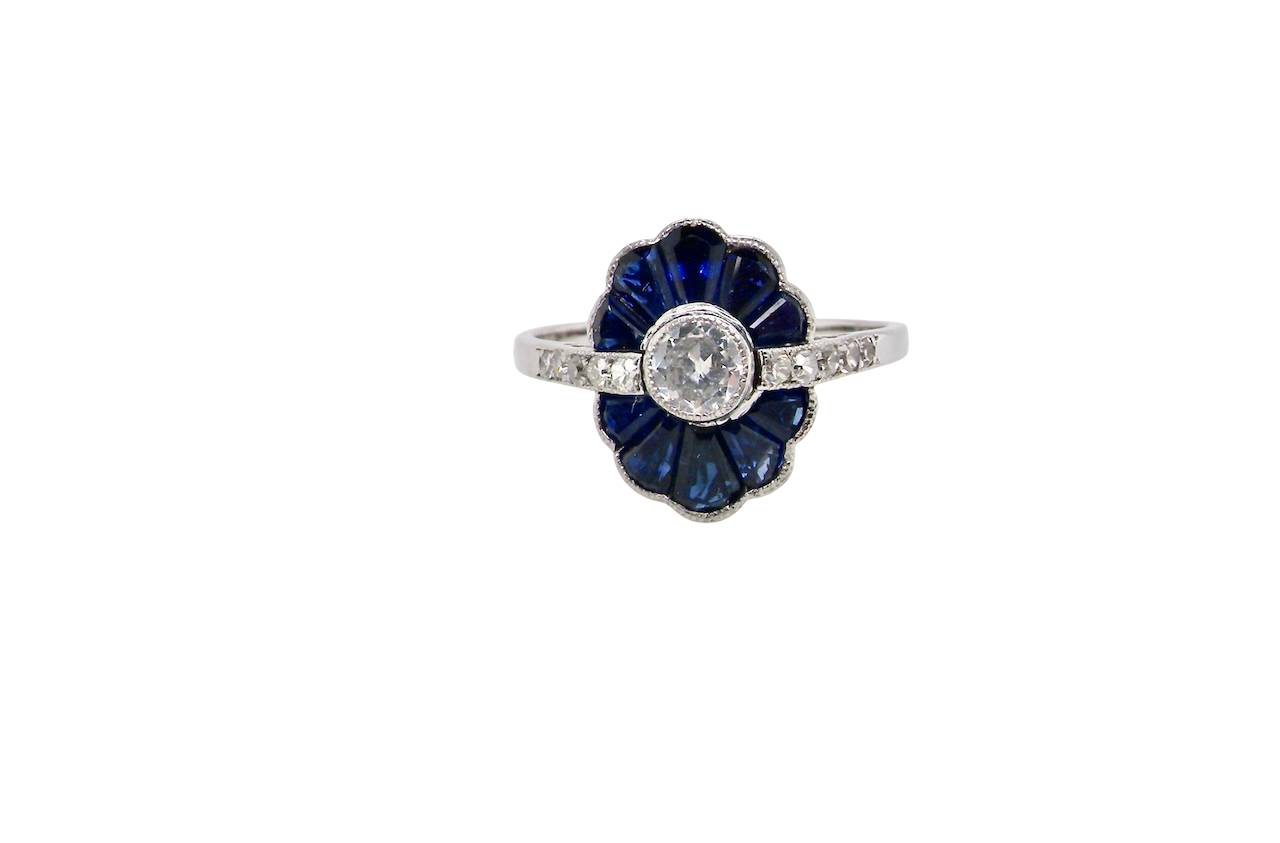 A striking and highly unusual Art Deco cluster ring featuring a distinctive fan-shaped design.
