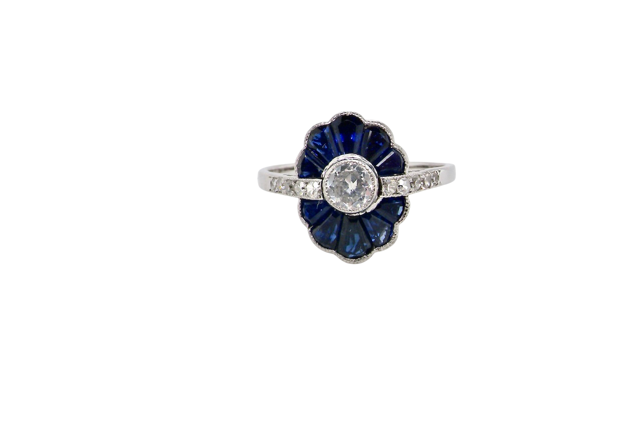A striking and highly unusual Art Deco cluster ring featuring a distinctive fan-shaped design.