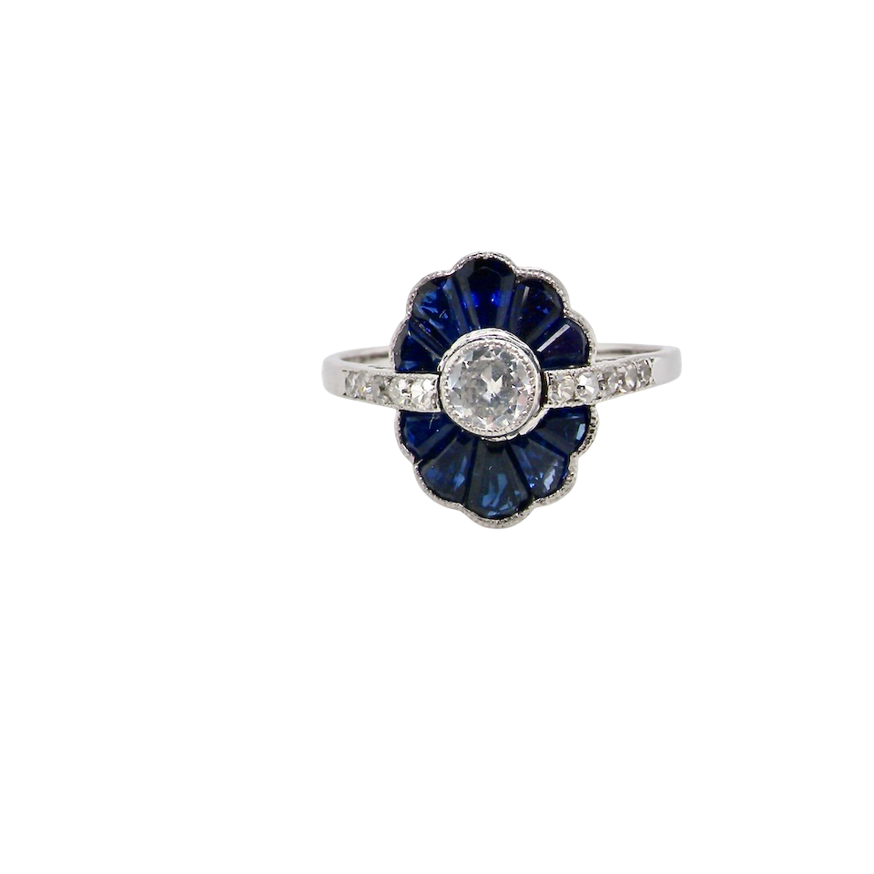 A striking and highly unusual Art Deco cluster ring featuring a distinctive fan-shaped design.