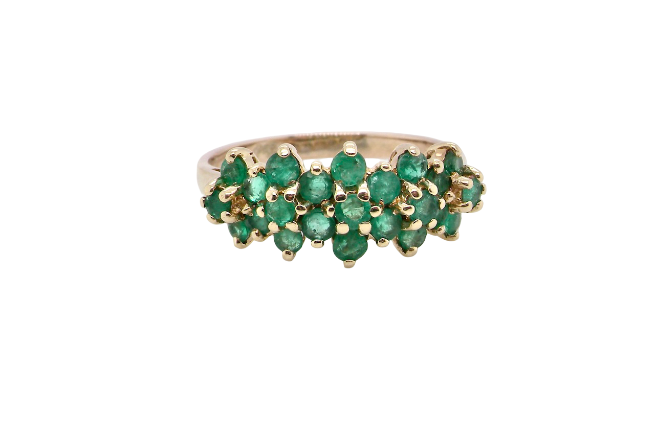 A striking and unusual dress ring, designed with multiple clusters of round-cut emeralds set beautifully across the finger for a bold, look.