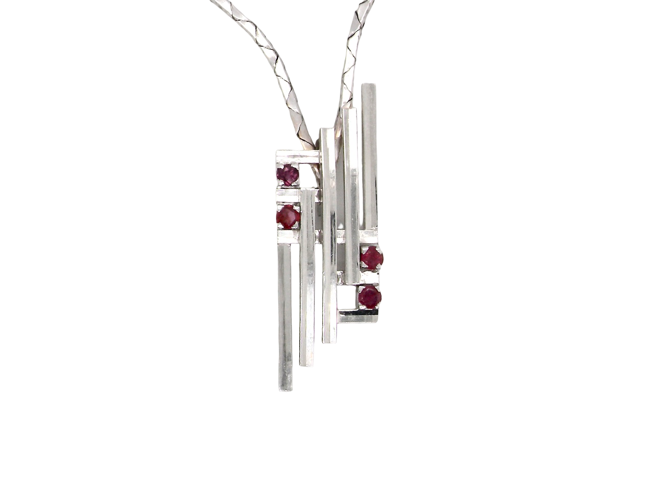 A striking modern pendant set with four 3mm rubies. The pendant measures approximately 40mm x 14mm and features a sleek design of five horizontal bars, with the outer bars