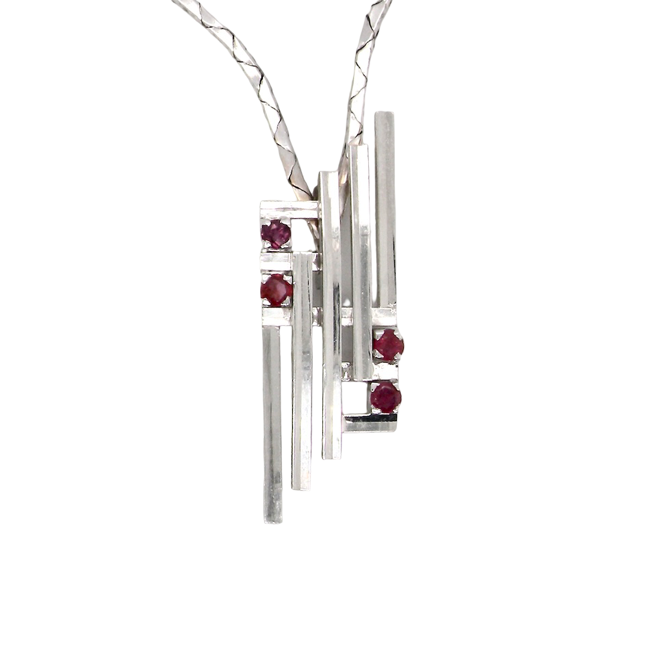 A striking modern pendant set with four 3mm rubies. The pendant measures approximately 40mm x 14mm and features a sleek design of five horizontal bars, with the outer bars