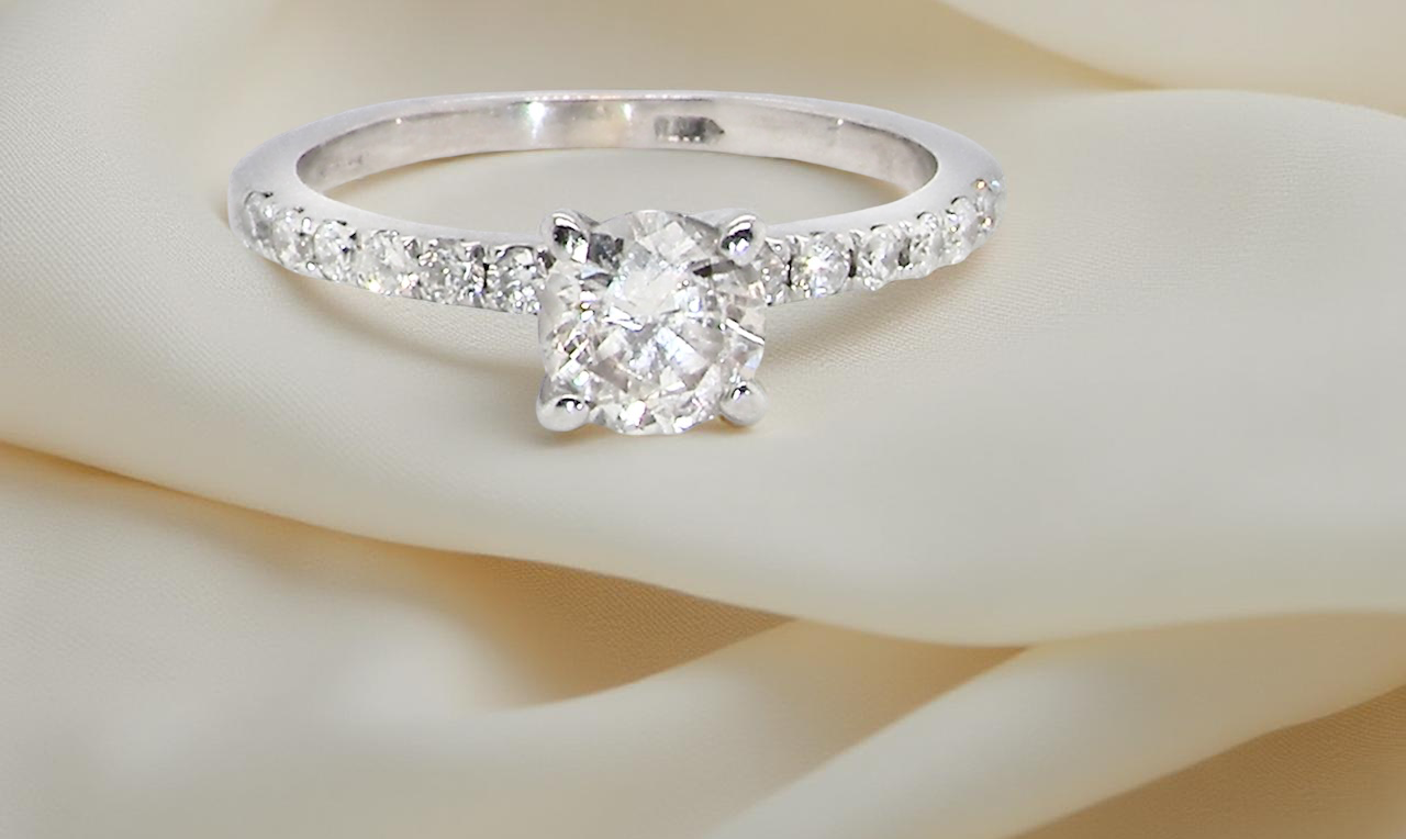 A stunning 14-carat white gold* solitaire ring featuring a t white diamond.