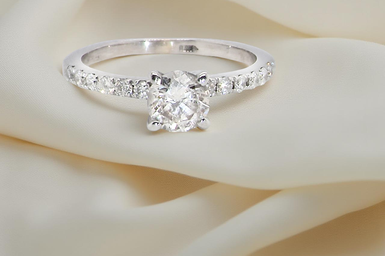 A stunning 14-carat white gold* solitaire ring featuring a t white diamond.
