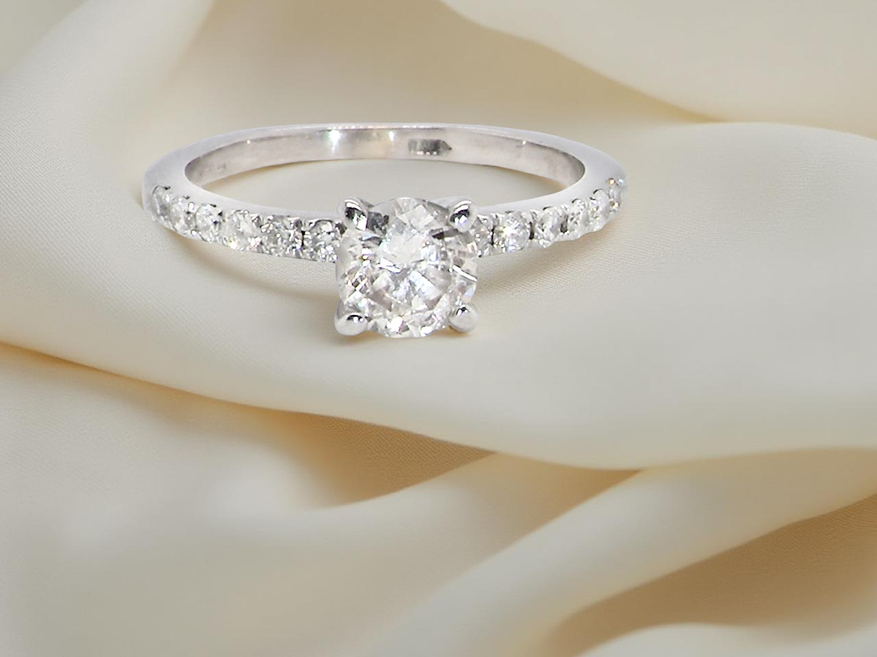 A stunning 14-carat white gold* solitaire ring featuring a t white diamond.