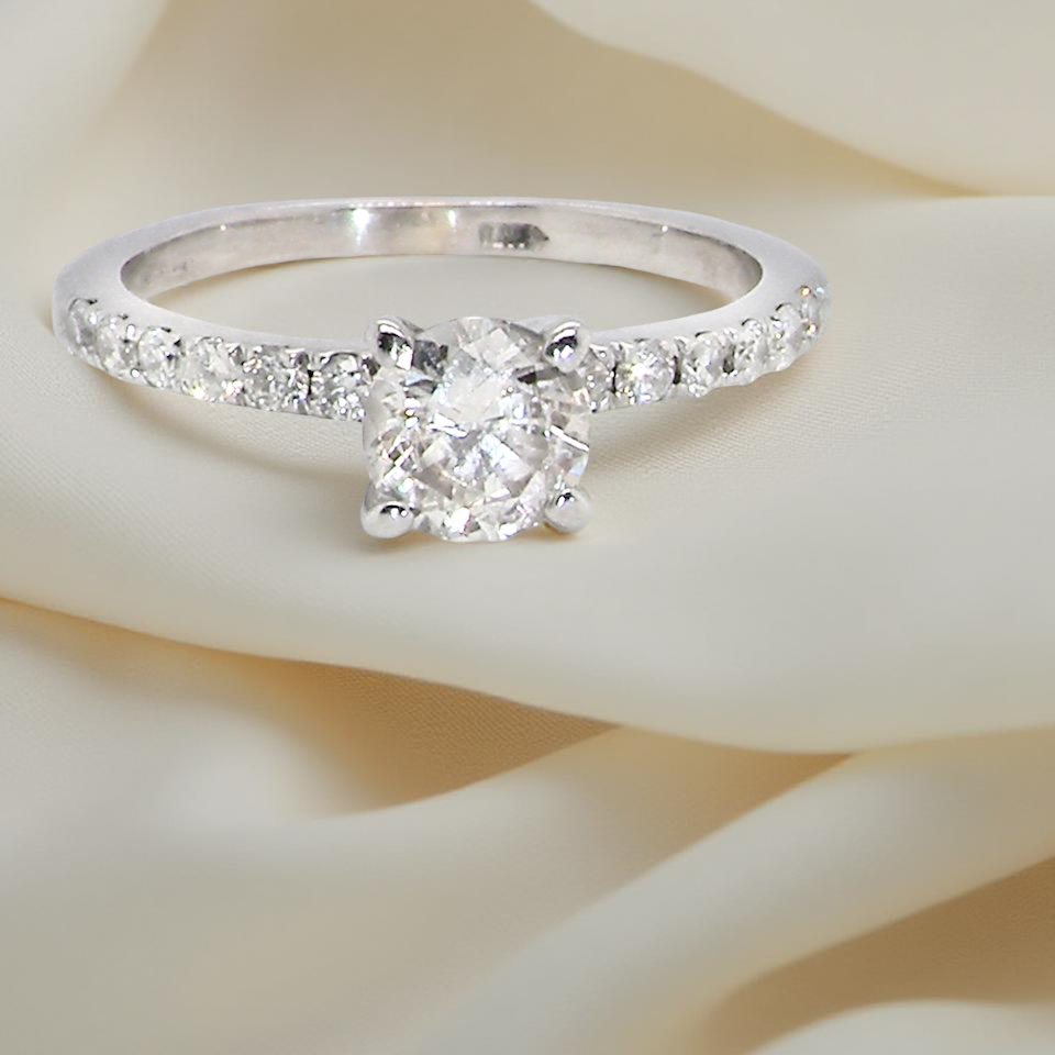 A stunning 14-carat white gold* solitaire ring featuring a t white diamond.
