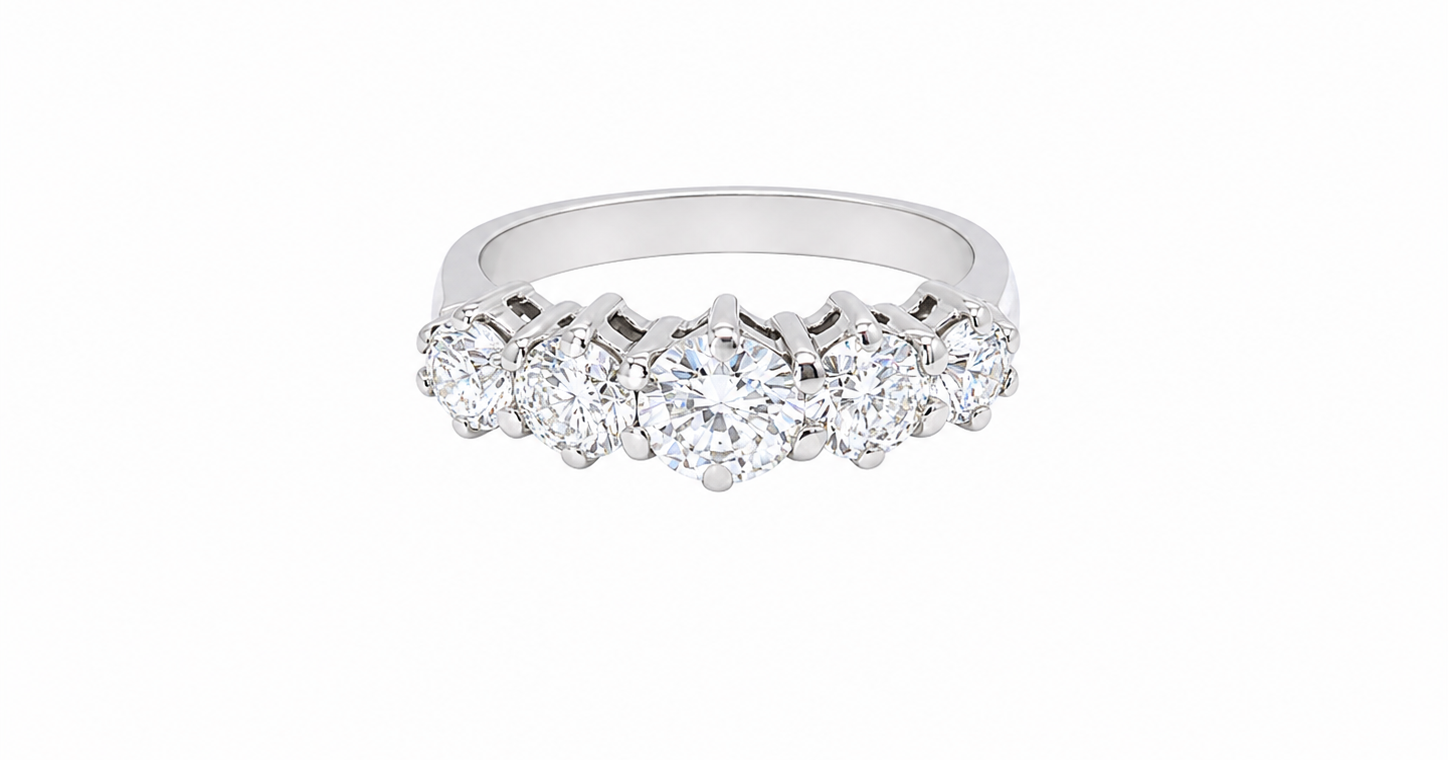 A stunning half hoop ring featuring five exceptional brilliant-cut white diamonds, expertly claw set in 18ct white gold.
The centre diamond measures approximately 5.8mm (estimated 0.70 carats), flanked by a 5.0mm diamond on each side, with 4.5mm diamonds at each end.