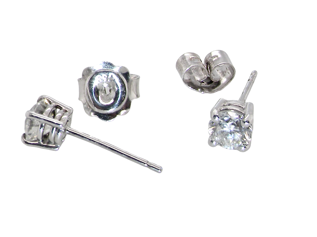 Four silver stud earrings shown on a plain white background, including front-facing and side/back views. The earrings feature clear gemstones in a prong setting with post and butterfly backings visible.