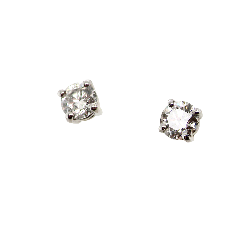 A pair of round-cut solitaire stud earrings in a silver-toned setting, displayed on a solid white background.