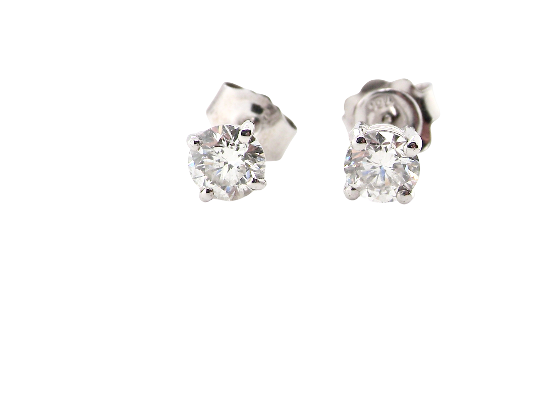 A pair of round-cut diamond stud earrings set in a silver-toned metal, shown from a side angle against a plain white background.