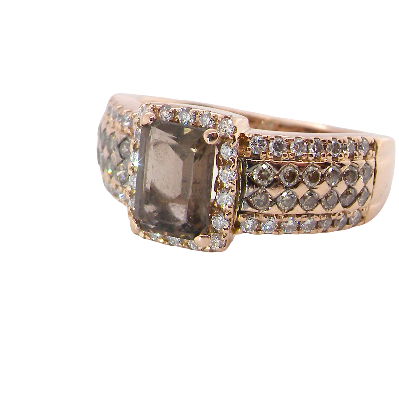 A stunning ring from the House of Le Vien. Crafted from 14ct Strawberry Gold, this Le Vian ring is characterised by a gallery of brown diamonds set into each shoulder