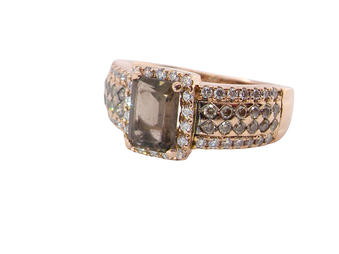 A stunning ring from the House of Le Vien. Crafted from 14ct Strawberry Gold, this Le Vian ring is characterised by a gallery of brown diamonds set into each shoulder