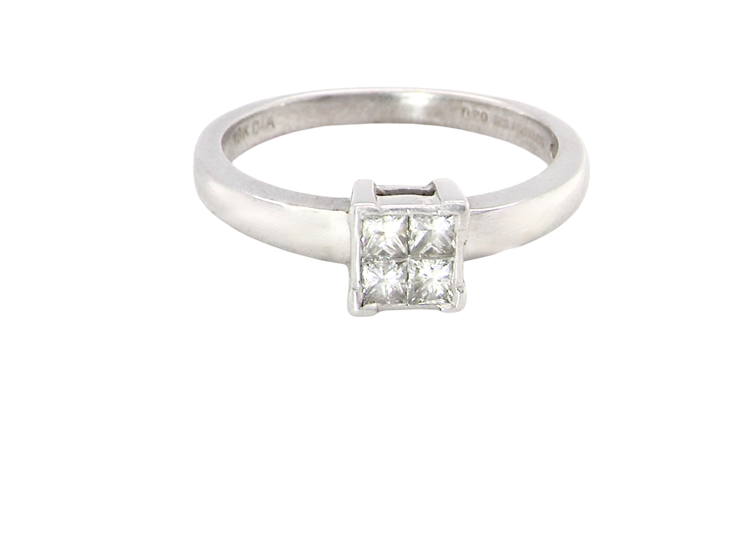 A stylish modern 18 carat white gold diamond cluster ring, with a beautifully clean and understated design.
The square-shaped head is set with 4 Princess cut white diamonds,
