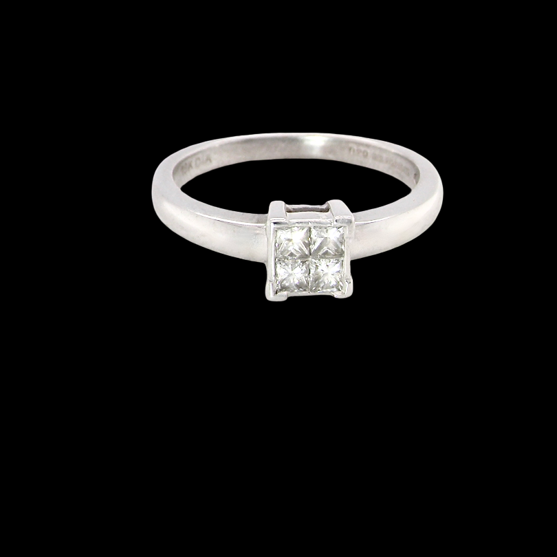 A stylish modern 18 carat white gold diamond cluster ring, with a beautifully clean and understated design.
The square-shaped head is set with four Princess cut diamonds,