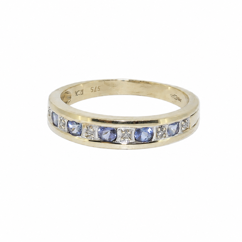 A tanzanite and diamond half eternity ring