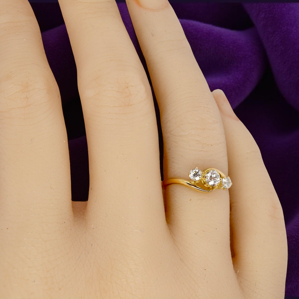 A three stone Diamond Cross Over ring