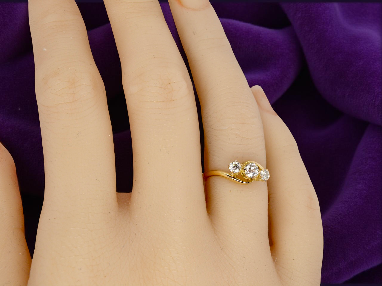 A three stone Diamond Cross Over ring