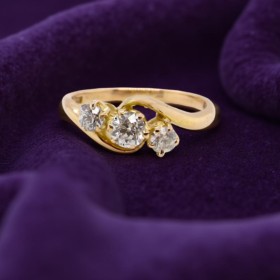 A three stone Diamond Cross Over ring