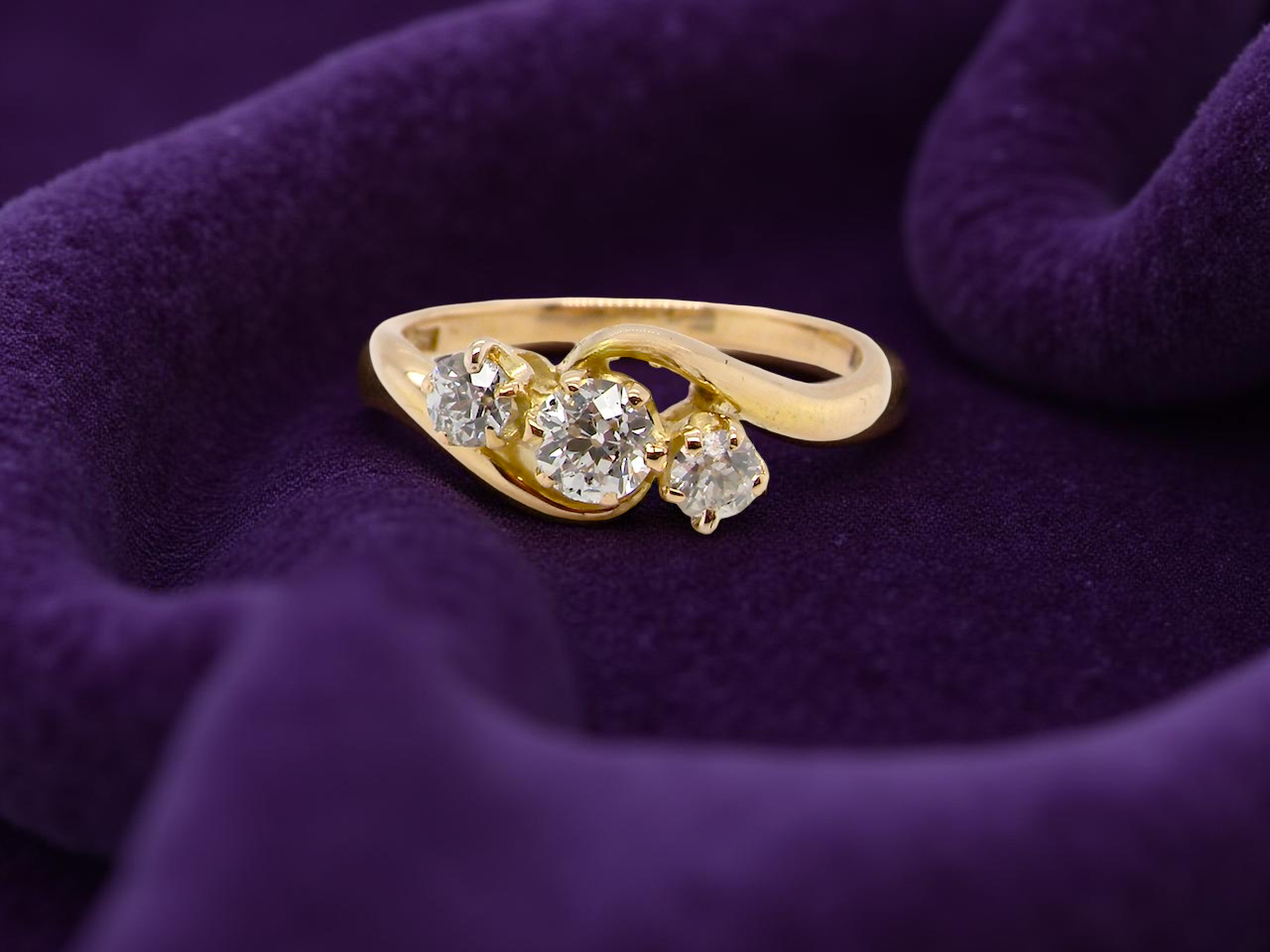 A three stone Diamond Cross Over ring