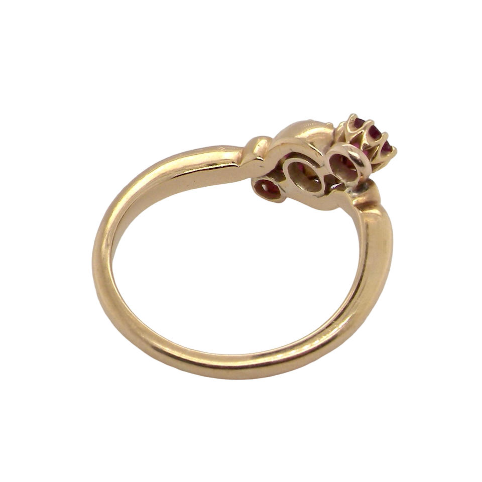 A three stone Ruby and Diamond cross over Ring