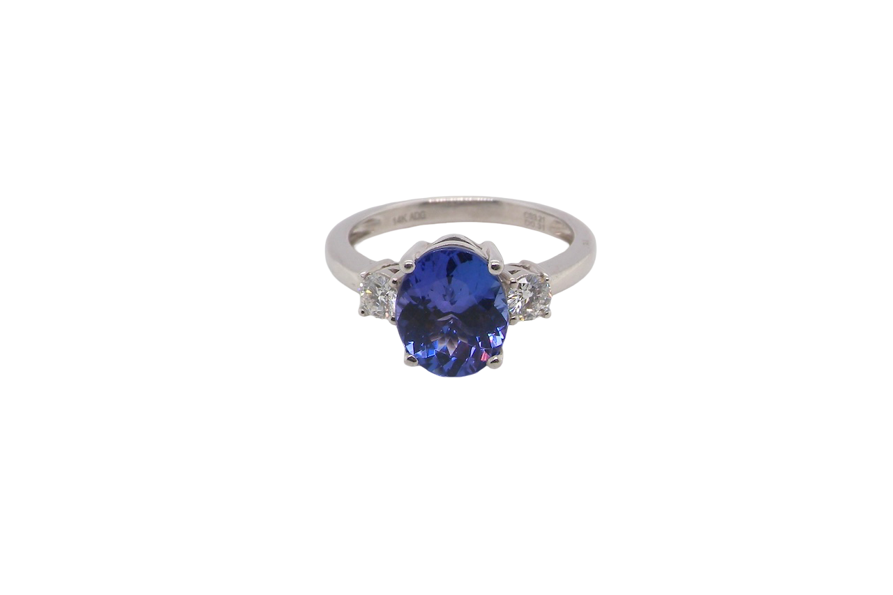 A three stone ring that features an impressive tanzanite centre stone that measures 10x8mm (3.21 carats confirmed) AAA colour. 