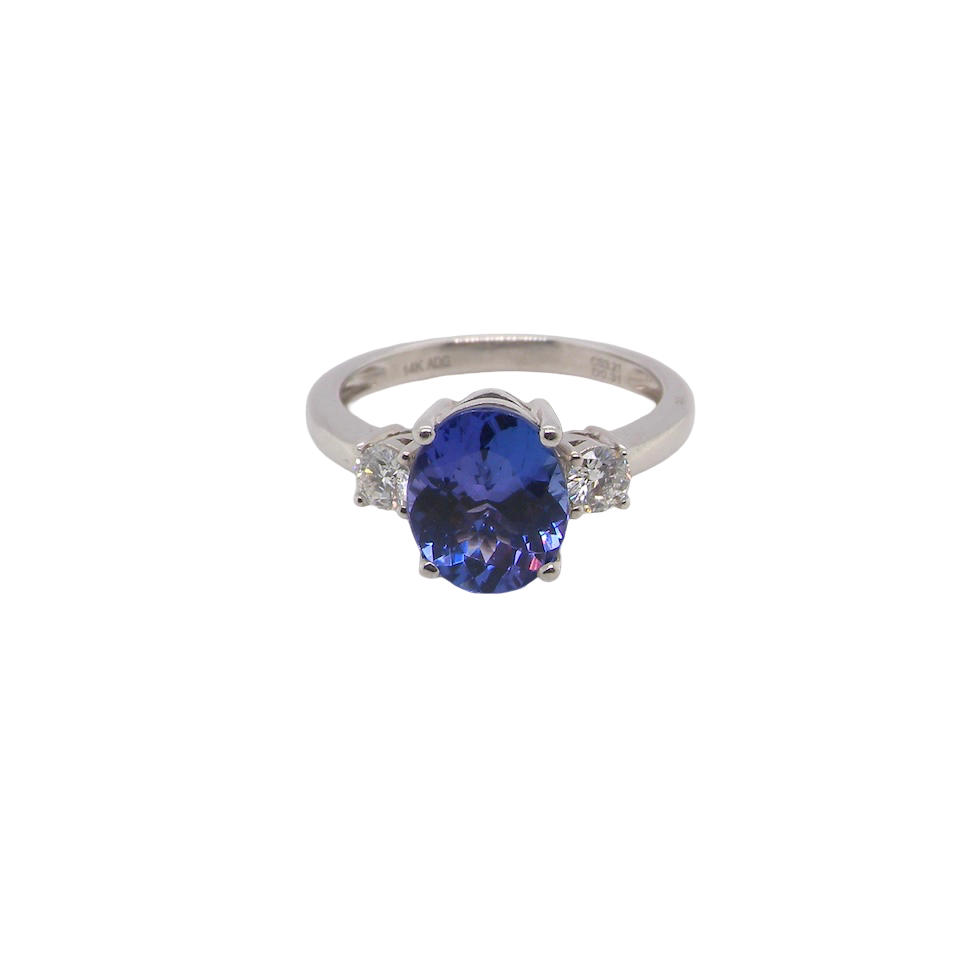 A three stone ring that features an impressive tanzanite centre stone that measures 10x8mm (3.21 carats confirmed) AAA colour. 